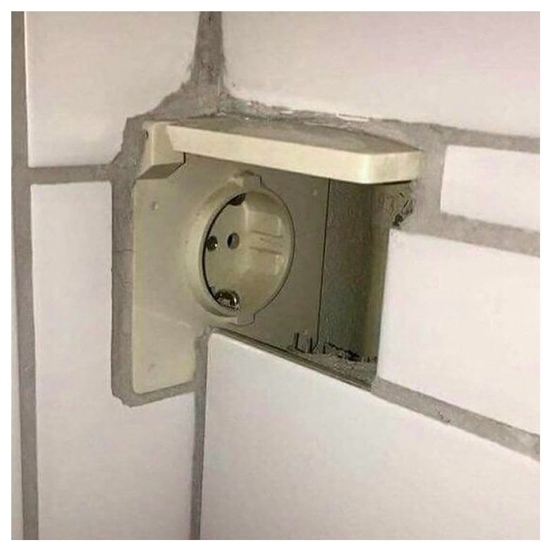 a wall mounted light switch in a bathroom